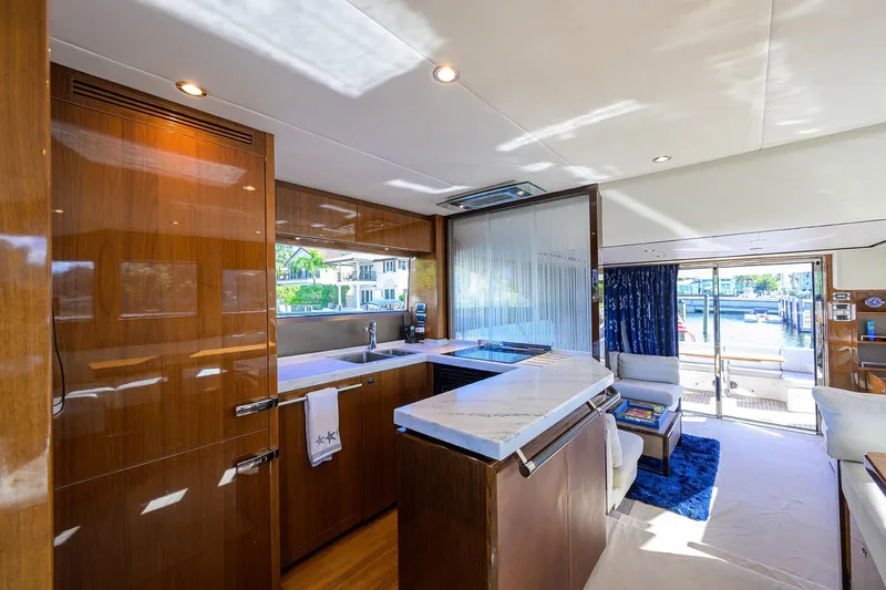 Tight Squeeze Yacht Photos Pics Luxurious interior of 2016 Princess F64 yacht with modern kitchen and elegant seating area.