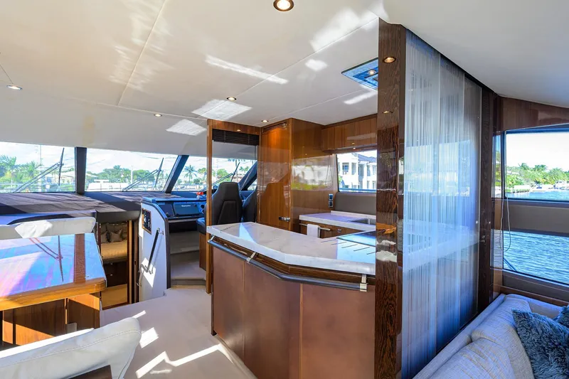 Tight Squeeze Yacht Photos Pics Luxurious interior of 2016 Princess F64 yacht with modern furnishings and panoramic windows.
