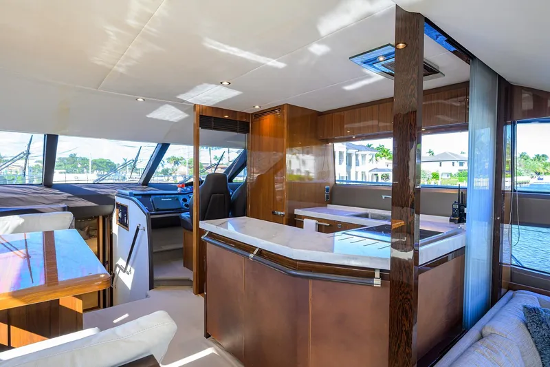 Tight Squeeze Yacht Photos Pics Luxurious interior of 2016 Princess F64 yacht with modern kitchen and seating area.