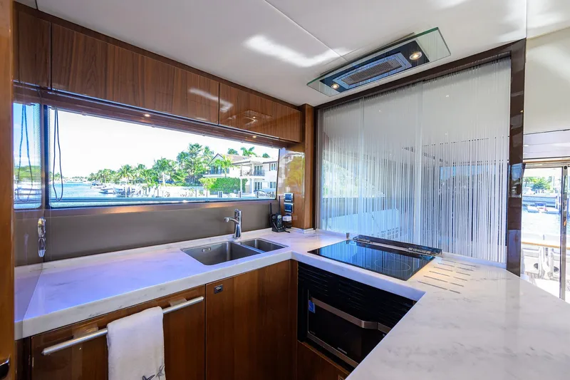 Tight Squeeze Yacht Photos Pics Luxurious kitchen interior of 2016 Princess F64 yacht with modern appliances and waterfront view.