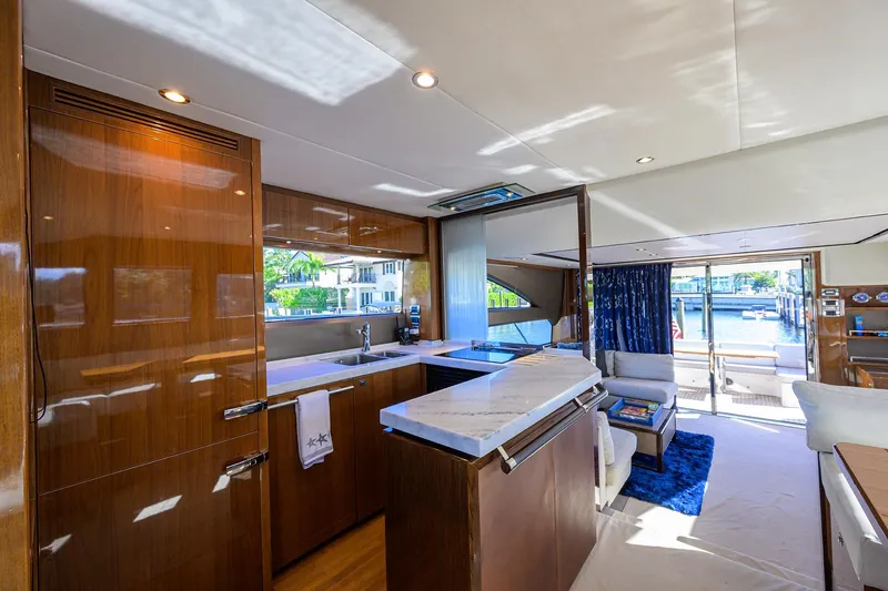 Tight Squeeze Yacht Photos Pics Luxurious interior of 2016 Princess F64 yacht with modern kitchen and waterfront view.