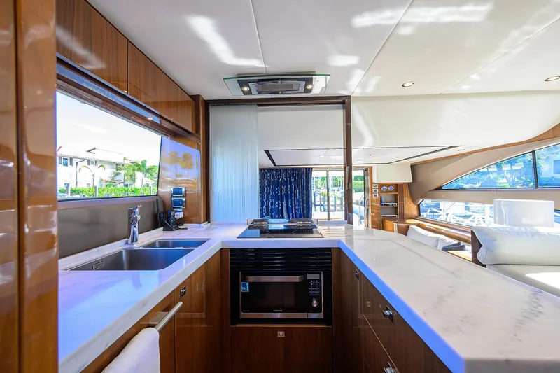 Tight Squeeze Yacht Photos Pics Luxurious interior of 2016 Princess F64 yacht with modern kitchen and panoramic windows.