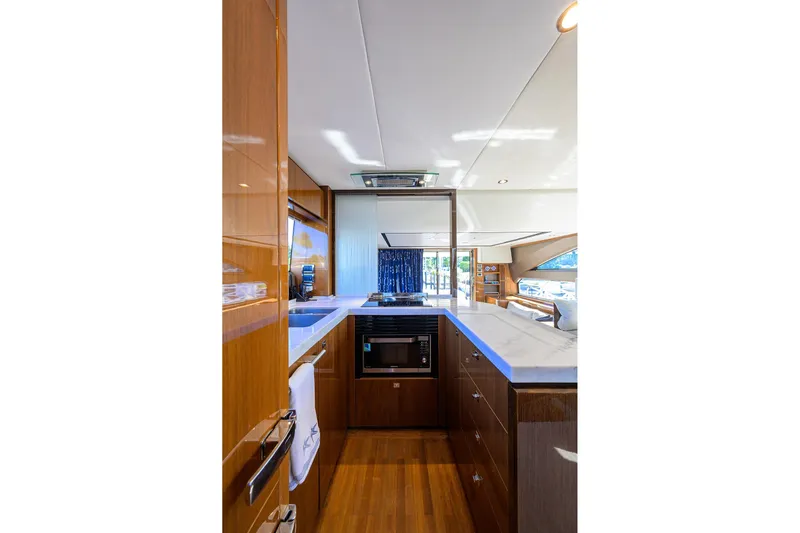 Tight Squeeze Yacht Photos Pics Luxurious kitchen interior of 2016 Princess F64 yacht with modern appliances and sleek design.