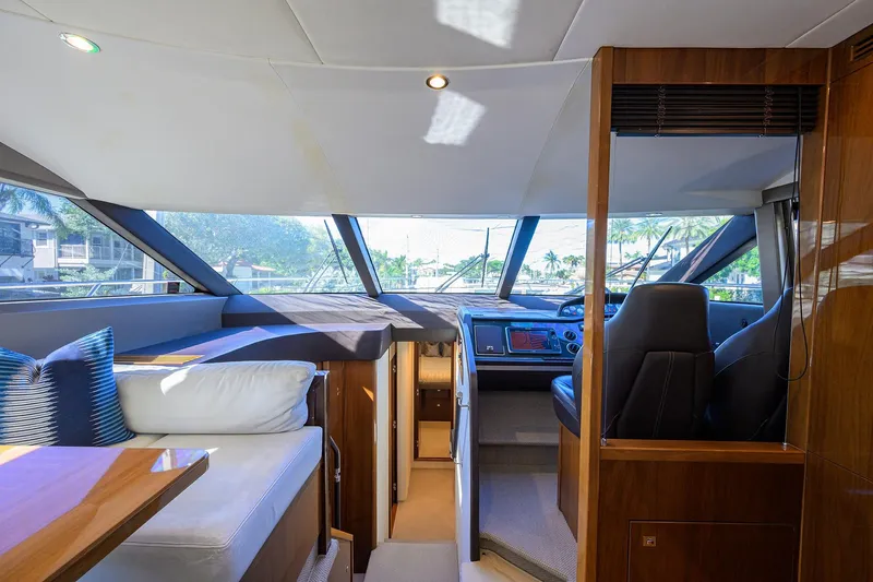 Tight Squeeze Yacht Photos Pics Luxurious interior of 2016 Princess F64 yacht with modern helm and seating area.