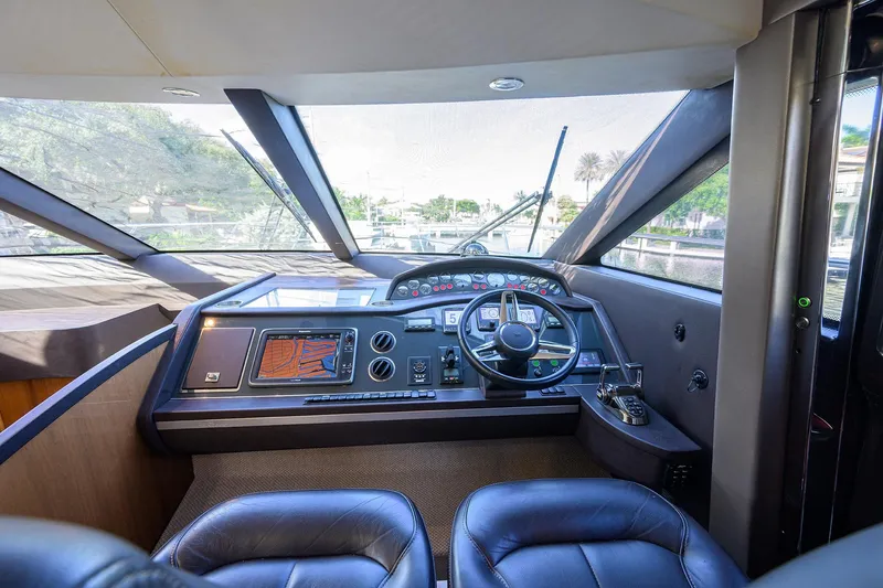 Tight Squeeze Yacht Photos Pics Luxurious 2016 Princess F64 yacht cockpit with modern navigation controls and panoramic windows.