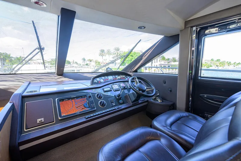 Tight Squeeze Yacht Photos Pics Luxurious 2016 Princess F64 yacht cockpit with modern navigation system and leather seating.