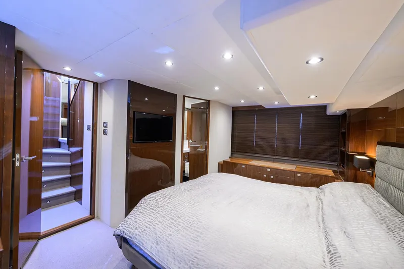 Tight Squeeze Yacht Photos Pics Luxurious bedroom interior of 2016 Princess F64 yacht with modern design and ambient lighting.