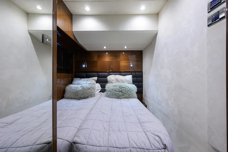 Tight Squeeze Yacht Photos Pics Luxurious bedroom interior in 2016 Princess F64 yacht, featuring plush bedding and modern lighting.