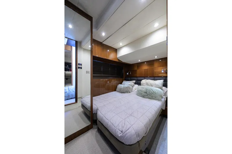 Tight Squeeze Yacht Photos Pics Luxurious cabin interior of 2016 Princess F64 yacht with twin beds and elegant wood paneling.