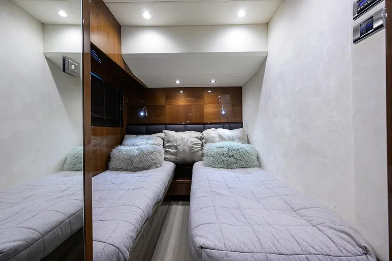 Tight Squeeze Yacht Photos Pics Luxurious twin cabin in 2016 Princess F64 yacht with plush bedding and modern lighting.