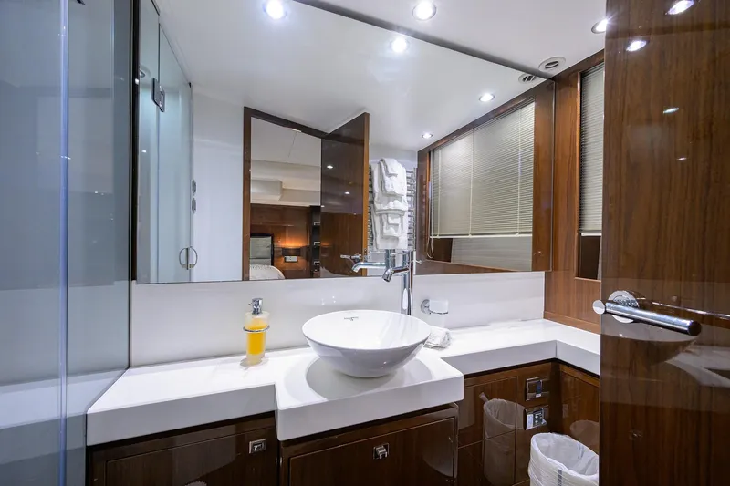 Tight Squeeze Yacht Photos Pics Luxurious bathroom in 2016 Princess F64 yacht with modern fixtures and elegant wood finishes.