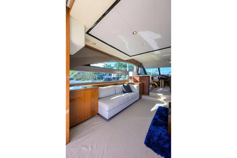 Tight Squeeze Yacht Photos Pics Luxurious interior of 2016 Princess F64 yacht with modern furnishings and panoramic windows.