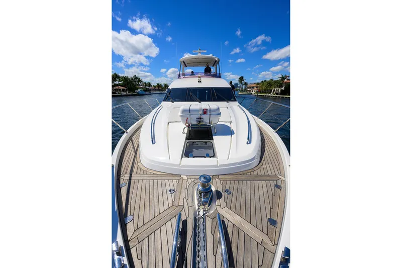 Tight Squeeze Yacht Photos Pics Luxurious 2016 Princess F64 yacht on a sunny day, featuring sleek design and spacious deck.
