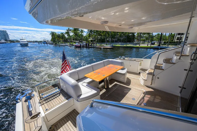 Tight Squeeze Yacht Photos Pics Luxurious 2016 Princess F64 yacht deck with seating, table, and scenic waterfront view.