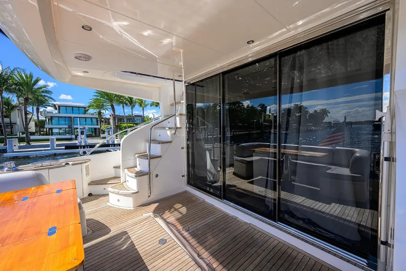 Tight Squeeze Yacht Photos Pics Luxurious 2016 Princess F64 yacht deck with spiral staircase and waterfront view.