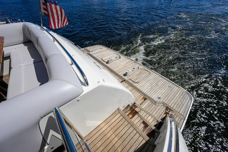 Tight Squeeze Yacht Photos Pics Luxury Princess F64 yacht deck with American flag, cruising on open water, 2016 model.