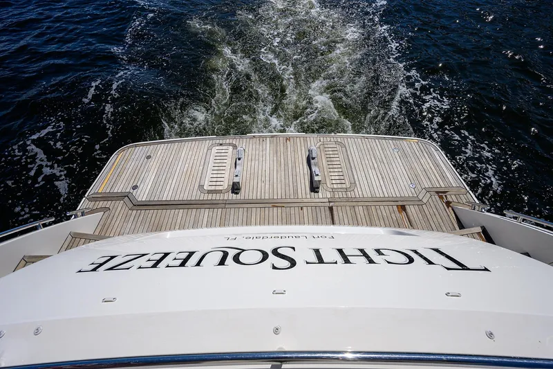 Tight Squeeze Yacht Photos Pics Stern view of 2016 Princess F64 yacht cruising on open water.