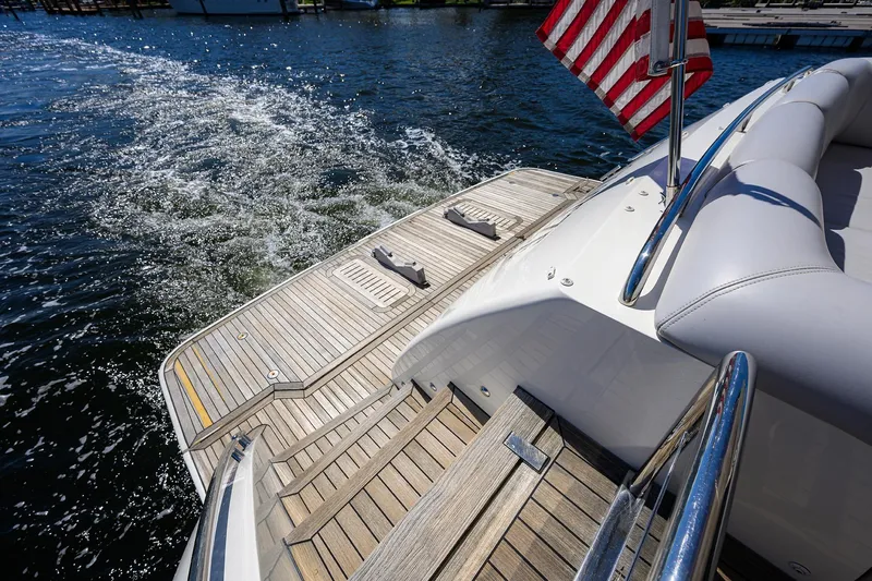 Tight Squeeze Yacht Photos Pics Luxury yacht Princess F64, 2016 model, cruising with American flag on sunny day.