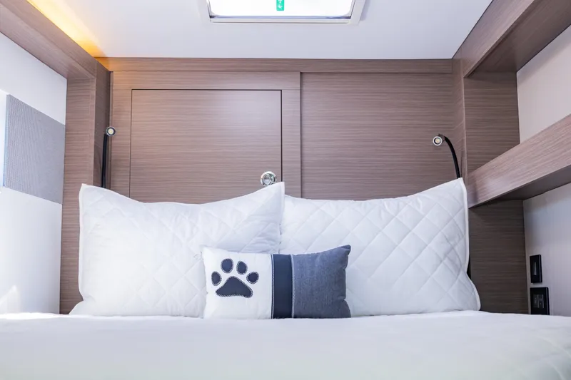 Mabinti Yacht Photos Pics Cozy cabin interior of 2024 Leopard 40 Powercat with plush pillows and modern wood paneling.