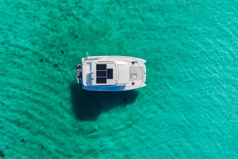 Mabinti Yacht Photos Pics Aerial view of 2024 Leopard 40 Powercat on clear turquoise water.