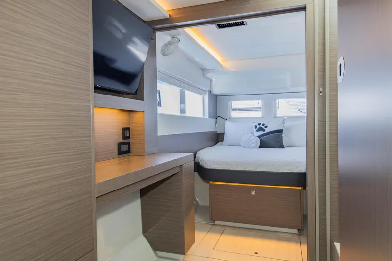 Mabinti Yacht Photos Pics 2024 Leopard 40 Powercat cabin interior with modern design, featuring a bed, TV, and ambient lighting.