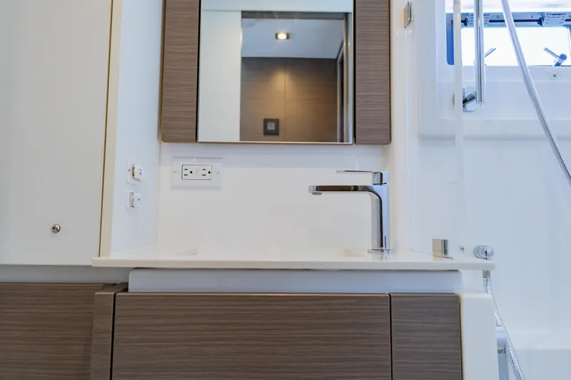 Mabinti Yacht Photos Pics Modern bathroom interior of 2024 Leopard 40 Powercat yacht, featuring sleek faucet and mirror.