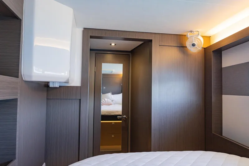Mabinti Yacht Photos Pics Interior of 2024 Leopard 40 Powercat cabin with modern wood paneling and cozy bedding.