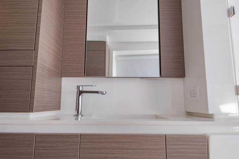 Mabinti Yacht Photos Pics Modern bathroom vanity on 2024 Leopard 40 Powercat yacht, featuring sleek faucet and mirror.