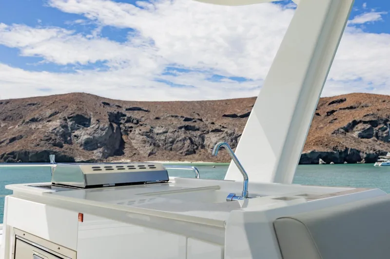 Mabinti Yacht Photos Pics 2024 Leopard 40 Powercat outdoor kitchen with scenic coastal backdrop.