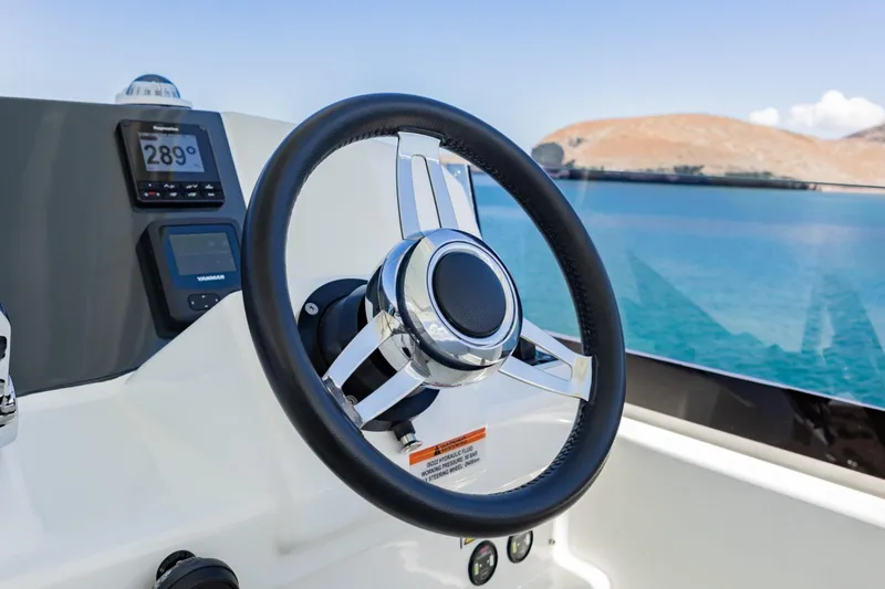 Mabinti Yacht Photos Pics Steering wheel of 2024 Leopard 40 Powercat with navigation instruments, ocean view.
