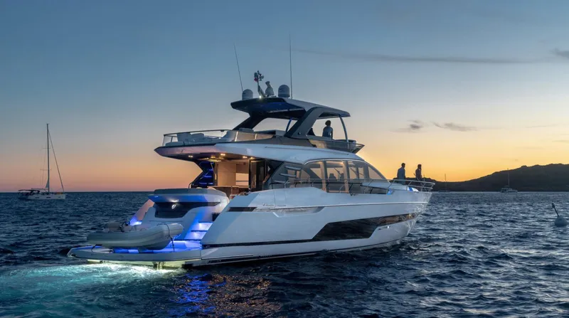  Yacht Photos Pics Luxury Fairline Squadron 68 yacht cruising at sunset, 2026 model, with illuminated deck.