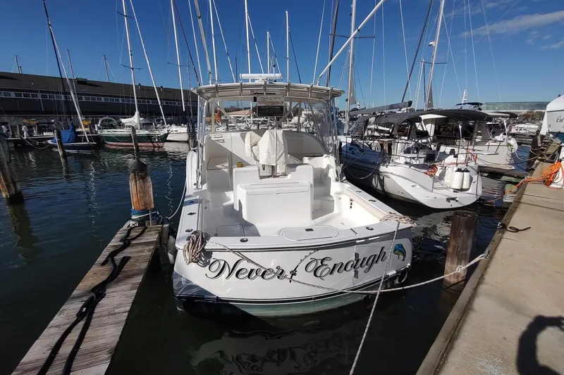 Never Enough Yacht Photos Pics 2017 Out Island SeaTek 36 Express docked at marina, sunny day, surrounded by boats.