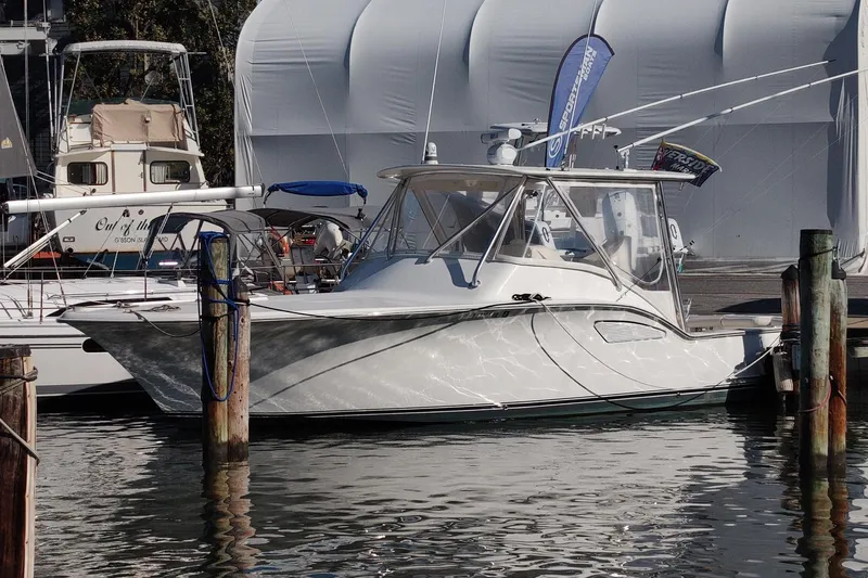 Never Enough Yacht Photos Pics 2017 Out Island SeaTek 36 Express boat docked at marina, featuring sleek design and modern amenities.