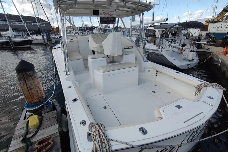 Never Enough Yacht Photos Pics 2017 Out Island SeaTek 36 Express boat docked at marina, featuring spacious deck and seating.