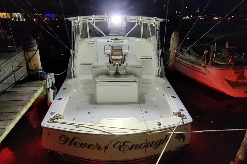 Never Enough Yacht Photos Pics 2017 Out Island SeaTek 36 Express boat docked at night, illuminated deck.