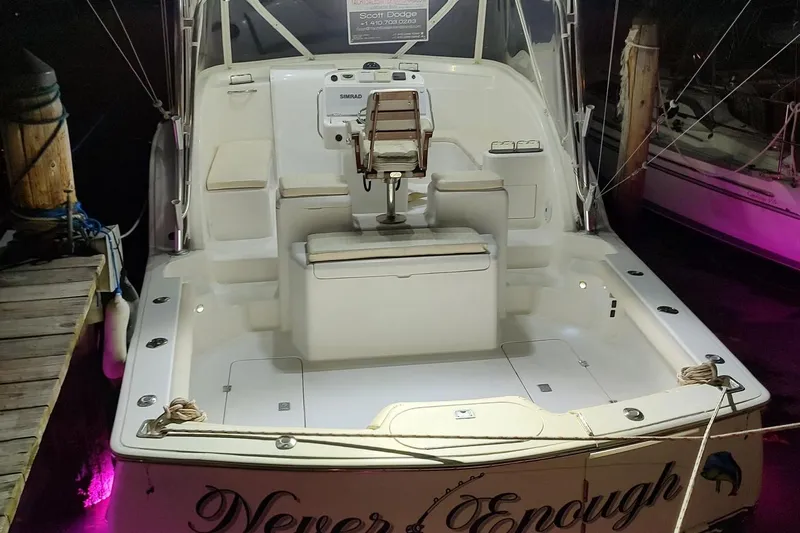 Never Enough Yacht Photos Pics 2017 Out Island SeaTek 36 Express boat docked at night, illuminated deck.