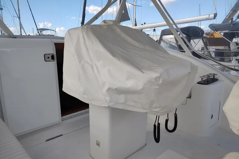 Never Enough Yacht Photos Pics 2017 Out Island SeaTek 36 Express boat helm covered, docked at marina.