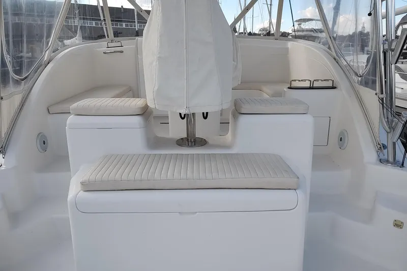 Never Enough Yacht Photos Pics 2017 Out Island SeaTek 36 Express boat interior with cushioned seating and covered helm.