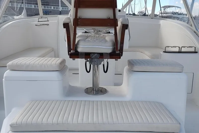 Never Enough Yacht Photos Pics 2017 Out Island SeaTek 36 Express boat interior with cushioned seating and helm chair.