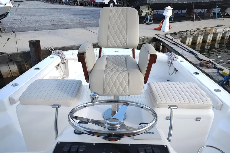 Never Enough Yacht Photos Pics 2017 Out Island SeaTek 36 Express boat interior with helm and seating.