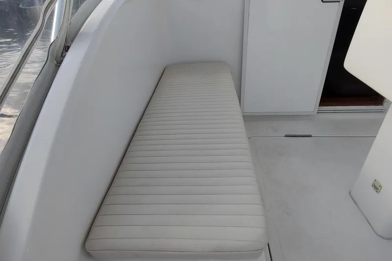 Never Enough Yacht Photos Pics 2017 Out Island SeaTek 36 Express interior with white cushioned seating.