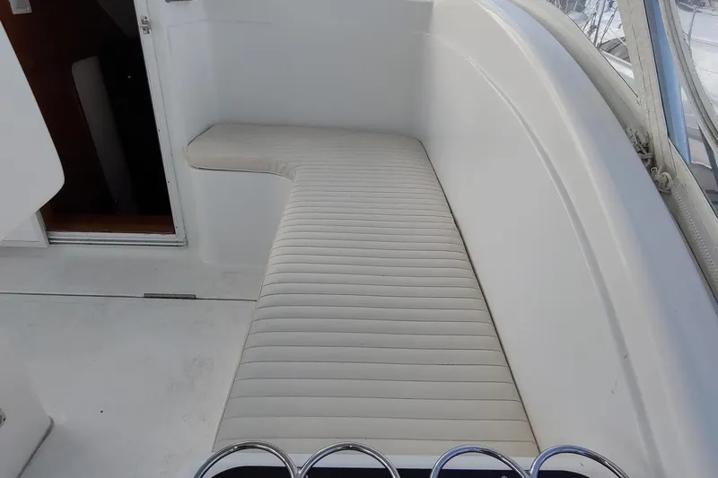 Never Enough Yacht Photos Pics 2017 Out Island SeaTek 36 Express boat interior with white cushioned seating.