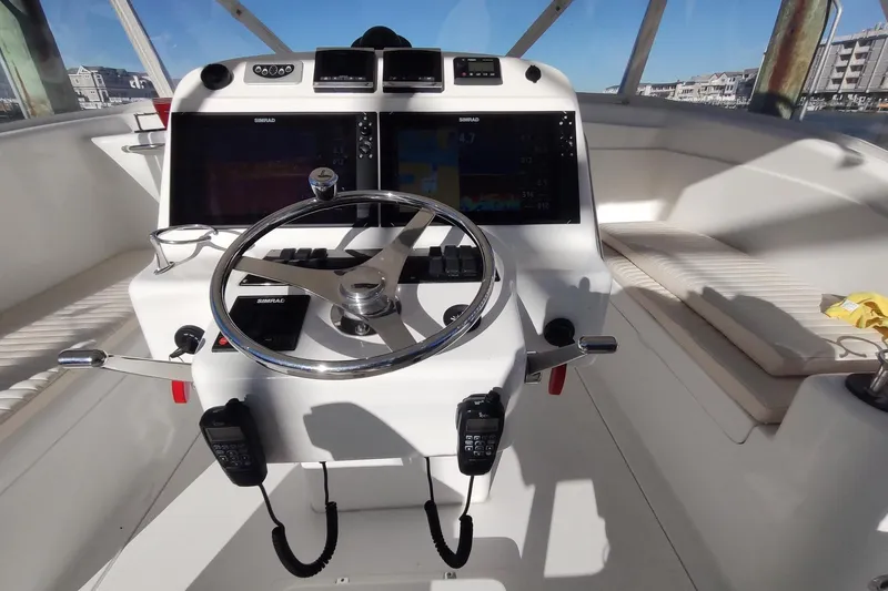 Never Enough Yacht Photos Pics Helm of 2017 Out Island SeaTek 36 Express with dual Simrad displays and steering wheel.