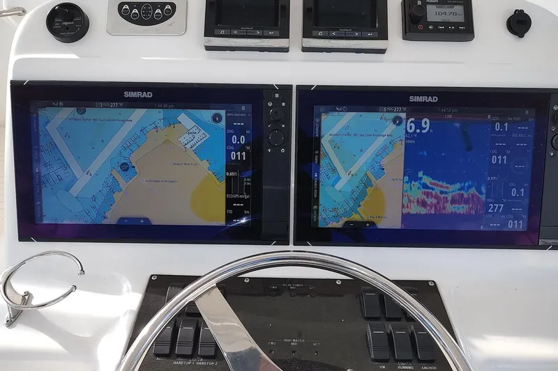 Never Enough Yacht Photos Pics Control panel of 2017 Out Island SeaTek 36 Express with dual Simrad navigation displays.