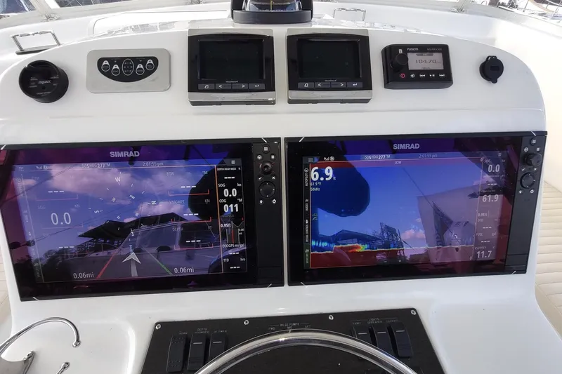 Never Enough Yacht Photos Pics Control panel of 2017 Out Island SeaTek 36 Express with dual Simrad displays.