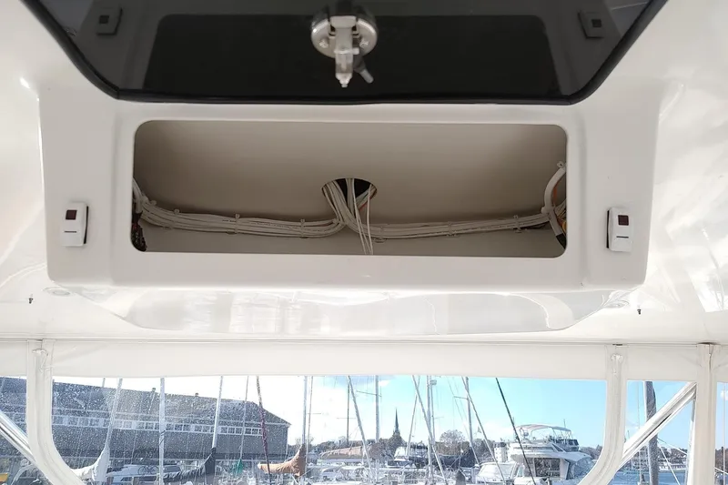 Never Enough Yacht Photos Pics 2017 Out Island SeaTek 36 Express boat interior with open storage compartment and visible wiring.