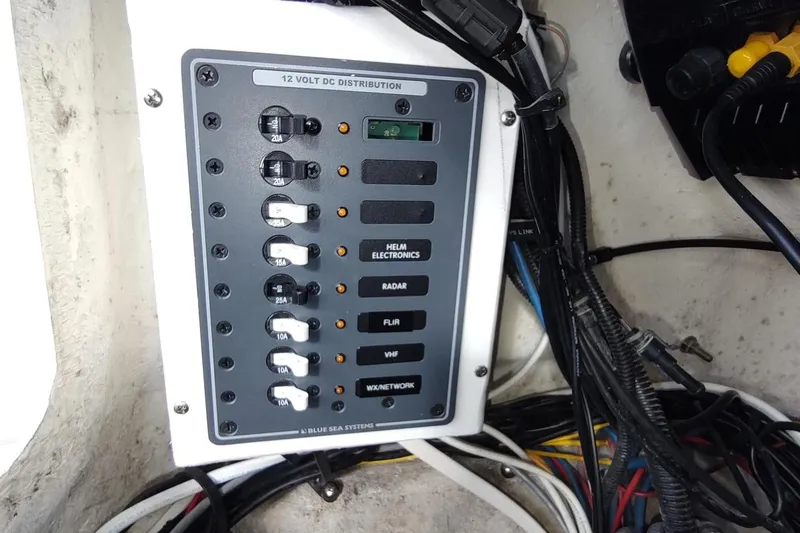 Never Enough Yacht Photos Pics Electrical panel on 2017 Out Island SeaTek 36 Express boat, featuring 12-volt DC distribution.