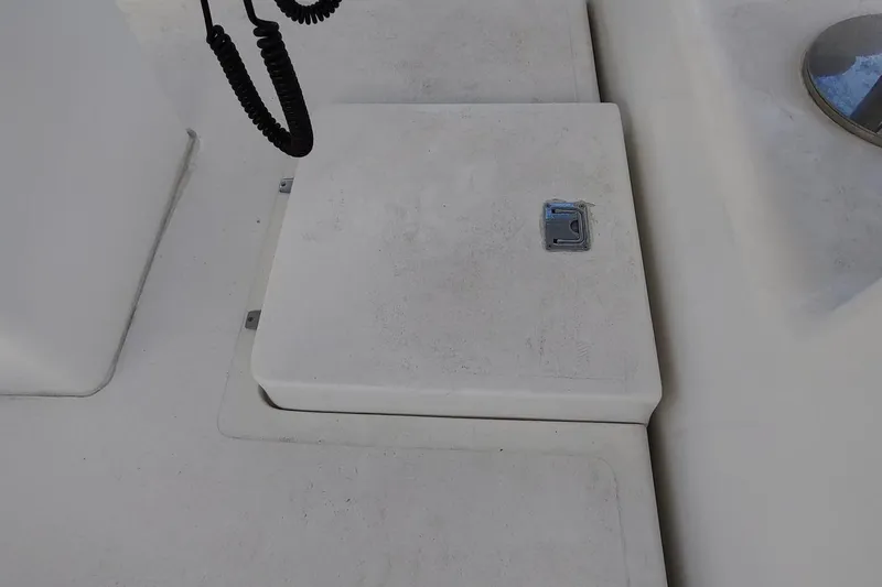 Never Enough Yacht Photos Pics 2017 Out Island SeaTek 36 Express deck with storage hatch and coiled cable.