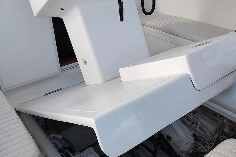 Never Enough Yacht Photos Pics 2017 Out Island SeaTek 36 Express boat interior with white seating and engine compartment.