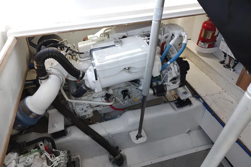 Never Enough Yacht Photos Pics Engine compartment of 2017 Out Island SeaTek 36 Express with visible fire extinguisher.